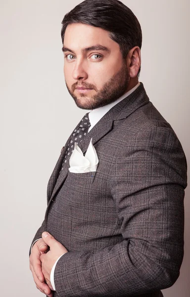 Elegant young handsome man in grey costume. Studio fashion portrait. — Stock Photo, Image