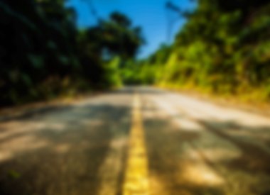 Beautiful blurred tropical view in defocus. Landscape photo with empty road. clipart