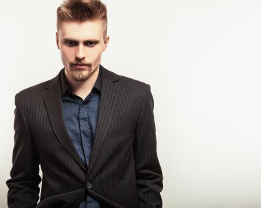 Siyah kostümlü zarif genç yakışıklı adam. Studio moda portre.