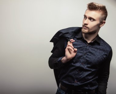 Tişörtlü zarif genç yakışıklı adam. Studio moda portre.