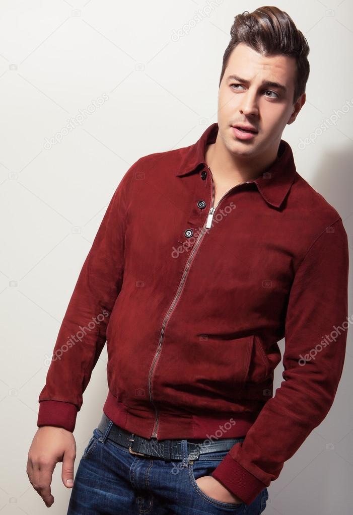 Elegant young handsome man in claret suede jacket. Studio fashion portrait.