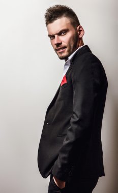 Zarif genç yakışıklı ciddi adam siyah kostüm. Studio moda portre.