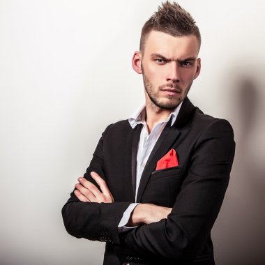 Zarif genç yakışıklı ciddi adam siyah kostüm. Studio moda portre.