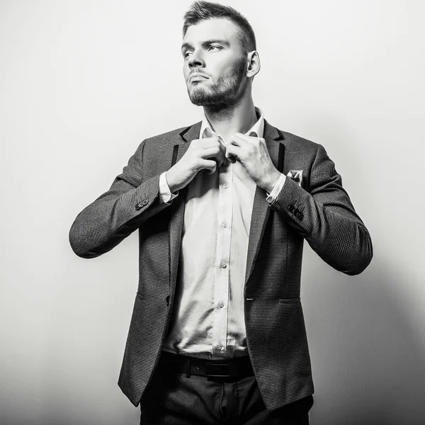 Elegant young handsome serious man in classic costume. Black-white studio fashion portrait. — Stock Photo, Image