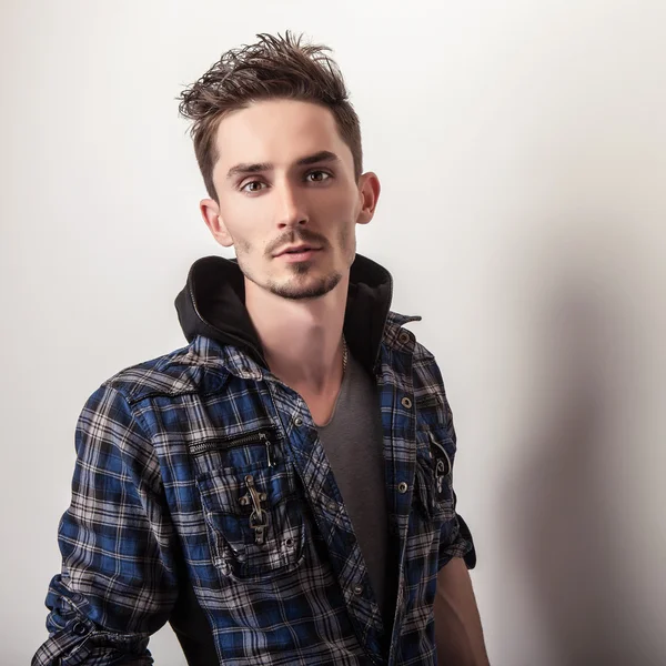 Studio portrait of young handsome man in stylish dark blue jacket. — Stock Photo, Image