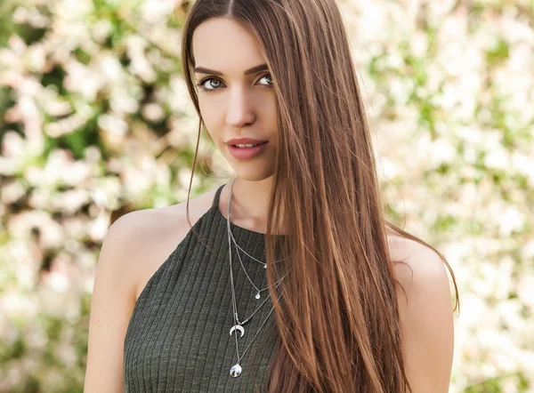 Outdoors portrait of beautiful young woman in fashionable green dress posing in summer garden. — Stock Photo, Image