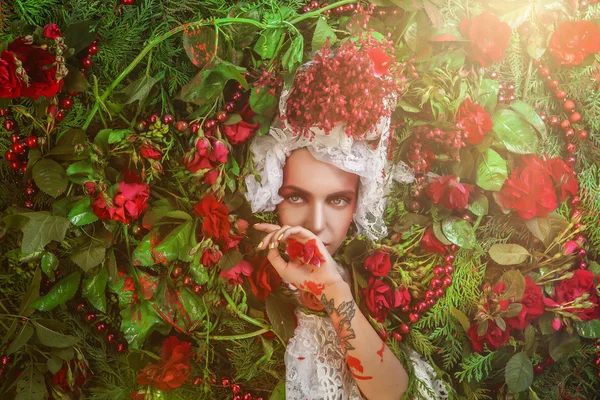 Fairy tale woman portrait surrounded with natural plants and roses. Art image in bright fantasy stylization. — Stockfoto