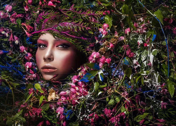 Fairy tale girl portrait surrounded with natural plants and flowers. Art image in bright fantasy stylization. — Stock Photo, Image