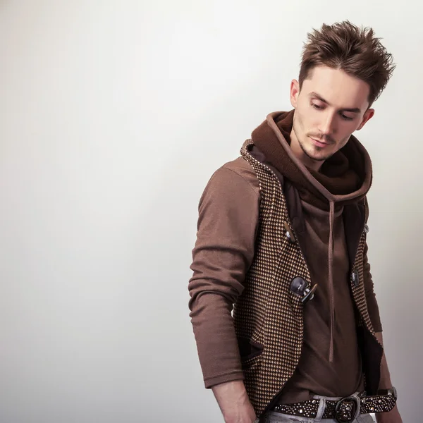 Attractive young man in brown sweater