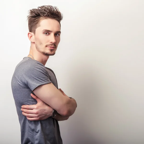 Young handsome man in grey t-shirt. — Stock Photo, Image