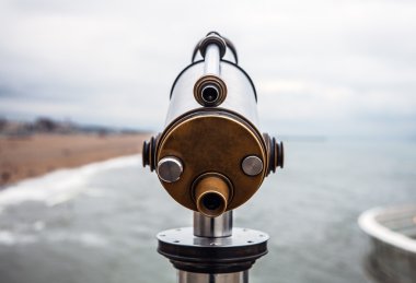 Telescope to observe the coastal landscape clipart