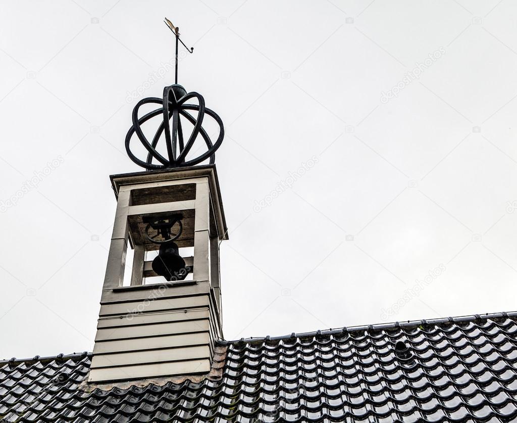 Roof of old house with bell tower
