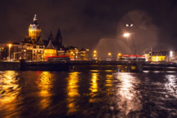 Nacht verlichting reflecties in Amsterdam kanalen verplaatsen cruise boot. Wazig abstracte foto als achtergrond. — Stockfoto