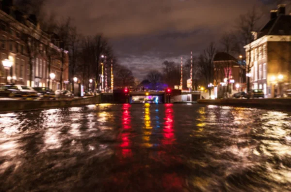 Reflejos de iluminación nocturna en los canales de Amsterdam desde el crucero en movimiento. Foto abstracta borrosa como fondo . — Foto de Stock