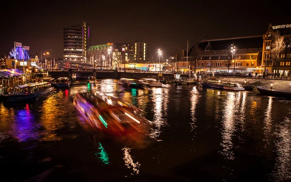 AMSTERDAM, PAÍSES BAJOS - 17 DE ENERO DE 2016: Crucero en los canales nocturnos de Ámsterdam el 17 de enero de 2016 en Ámsterdam - Países Bajos . — Foto de Stock