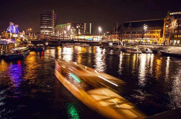 Amsterdam, Nederländerna - 17 januari 2016: Kryssning båt i natt kanalerna i Amsterdam på 17 januari 2016 i Amsterdam - Nederländerna. — Stockfoto