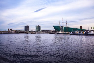 AMSTERDAM, NETHERLANDS - JANUARY 15, 2016: Nemo (Science) Museum, designed in form of  ship by architect Renzo Piano and seen from water in Amsterdam, Netherlands, on January 15, 2016.