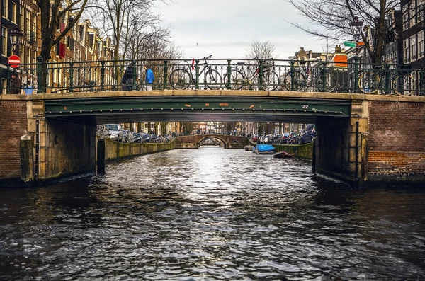 NETHERLANDS, AMSTERDAM - JANUARY 15, 2016: Bridge on river channel in January. Amsterdam - Netherlands. — Stockfoto