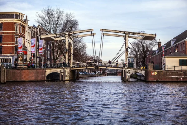 NETHERLANDS, AMSTERDAM - JANUARY 15, 2016: Bridge on river channel in January. Amsterdam - Netherlands. — Stock fotografie