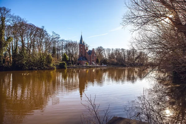 Medieval building (Castle) on Love lake, Minnewater Park in Bruges, Belgium