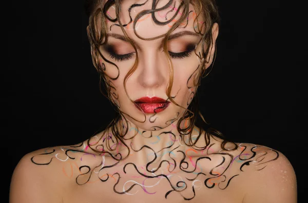 Young woman with wet hair and face art — Stock Photo, Image