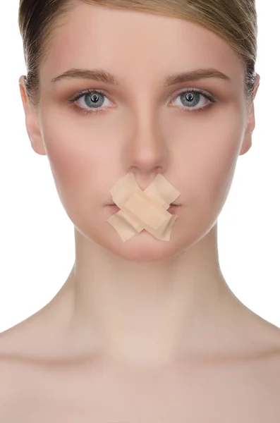 Face of beautiful woman with plaster on her lips — Stock Photo, Image