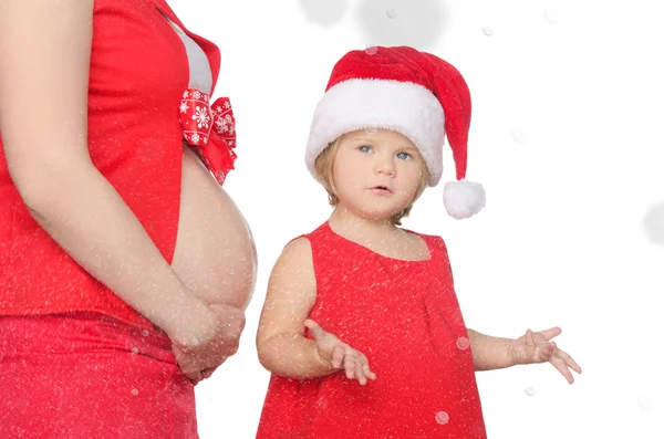 Překvapený dítě a těhotná žena na Vánoce, sněhové vločky — Stock fotografie