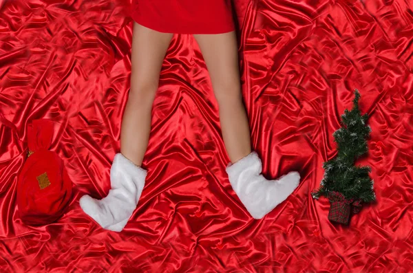 Female foot Christmas tree and bag of gifts — Stock Photo, Image