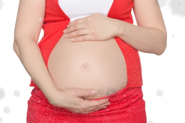 Abdomen of pregnant woman with falling snow — Stock Photo, Image