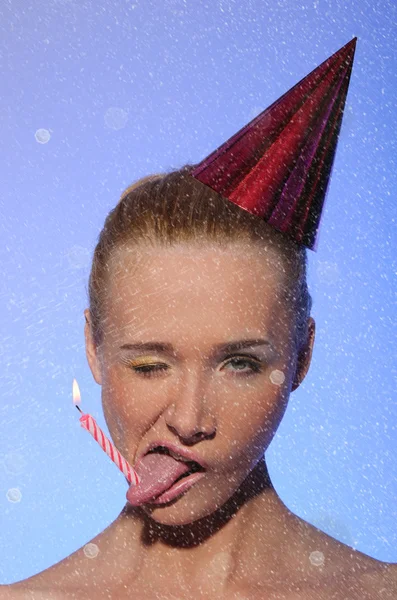 Woman with cap on his head, candle, snow — Stock Photo, Image