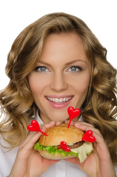 Beautiful young woman with hamburger from hearts — Stock Photo, Image