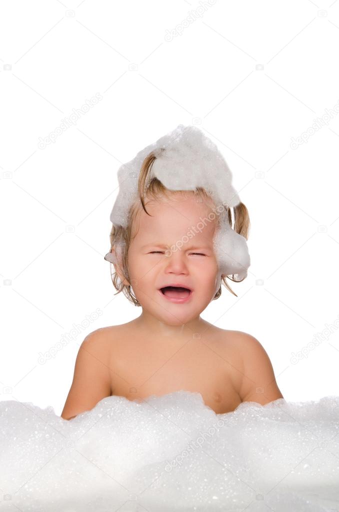 Crying child with soap foam 