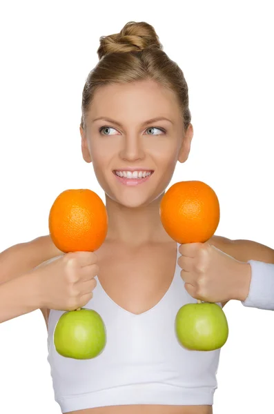 Beautiful woman with dumbbells fruits looking away — Stock Photo, Image