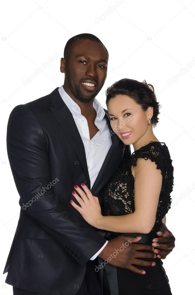 Black man hugging  smiling asian woman
