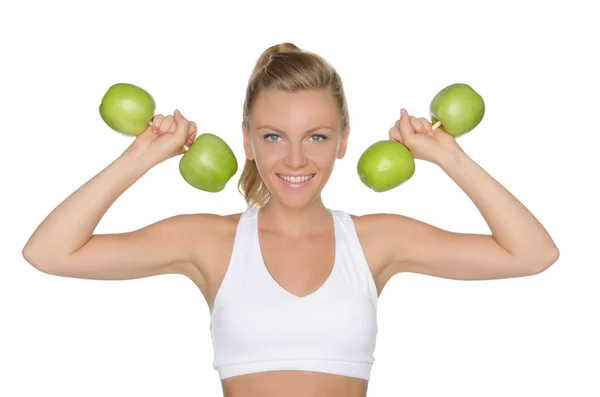 Young woman with dumbbells from ripe apples — Stock Photo, Image