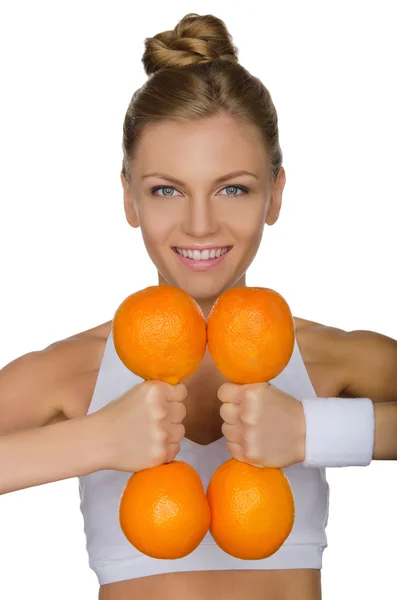 Menina segurando halteres de laranjas — Fotografia de Stock