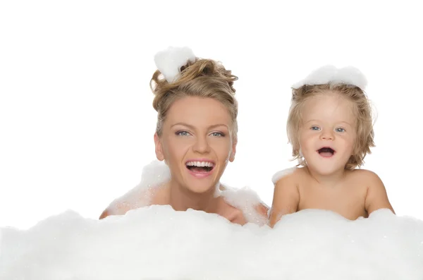 Young mother with her daughter and soap foam — Stock Photo, Image