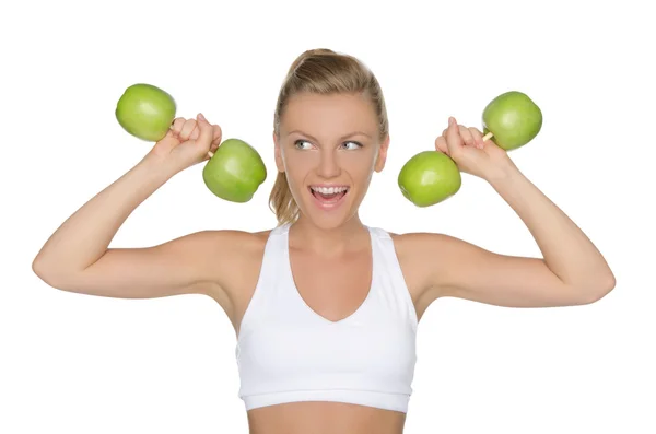 Woman with dumbbells from apples looking away — Stock Photo, Image