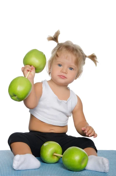 Little girl with weights of green apples — Stock Photo, Image