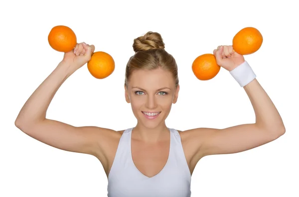 Beautiful woman with dumbbells from ripe oranges — Stock Photo, Image
