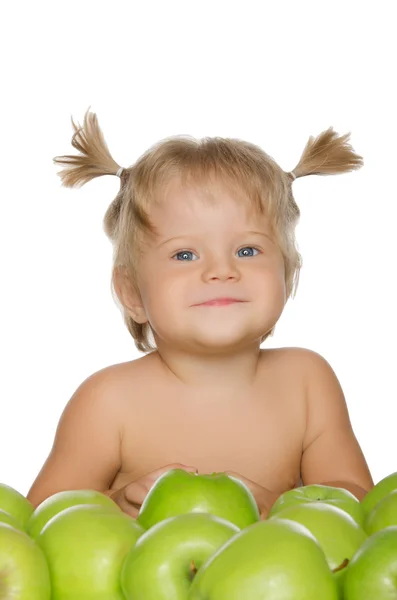 Little happy girl with green apples — Stock Photo, Image