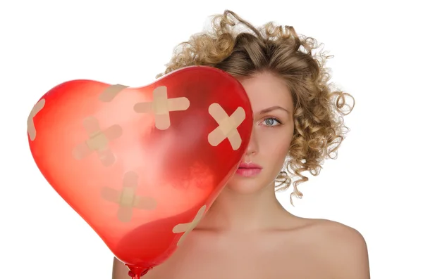 Balloon in shape of heart and hurt woman — Stock Photo, Image