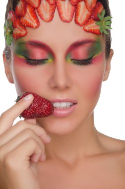 smiling woman with strawberries on face and hand