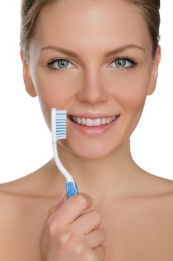 Beautiful woman with toothbrush in mouth
