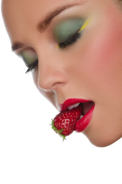 Face of beautiful woman with strawberry in mouth — Stock Photo, Image