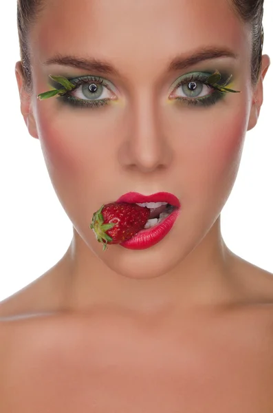 Face of charming woman with strawberry in mouth — Stok fotoğraf