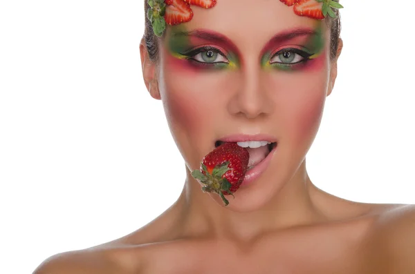 Young woman with strawberries on face and teeth — Stok fotoğraf