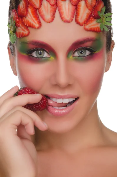 Beautiful woman with strawberries on face and hand — Stock Photo, Image