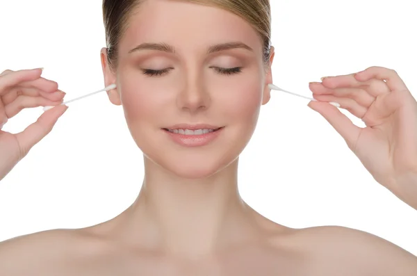 Charming woman cleans ears with cotton sticks — Stok fotoğraf