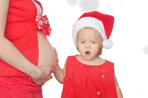 Überraschte Kind und schwangere Frau in Weihnachten, Schneeflocken — Stockfoto